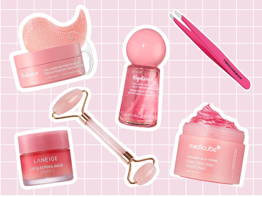 Pink flat lay on a grid: eye patches, gua sha, roller, mist, lip mask, jelly cream and tweezers